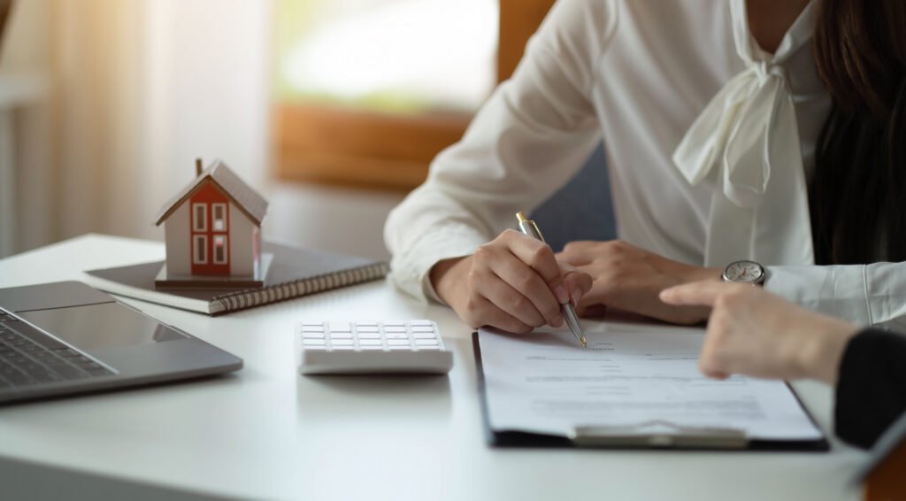 House model with agent and customer discussing for contract to buy, get insurance or loan real